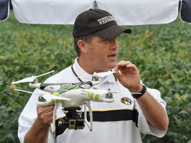 Kent Shannon, a natural resources engineering specialist, displayed drones at a MU field day, while stressing that the FAA has proposed classifying the use of drones in farming as a commercial activity. (DTN photo by Emily Unglesbee)
